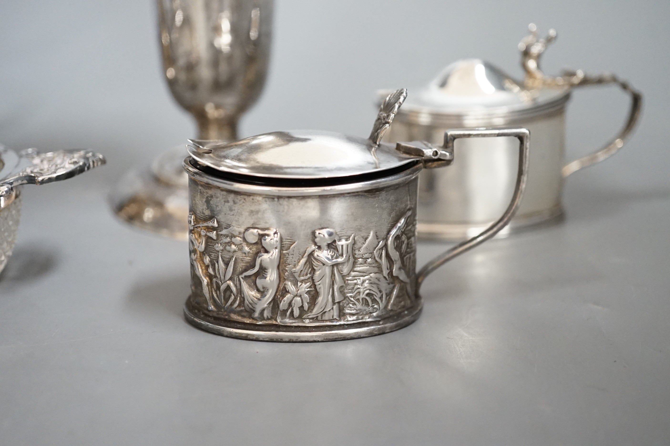 A group of assorted small silver items to include a posy vase, silver-mounted cut glass quaich, a twin-handled silver cup and three condiments.